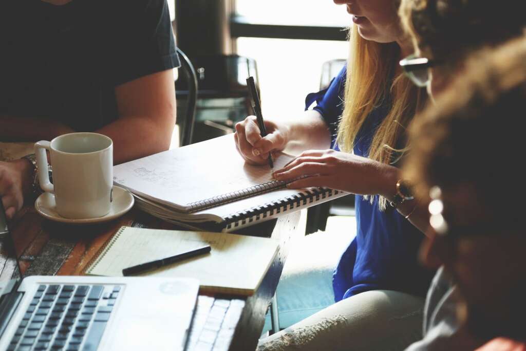 woman taking notes on a table